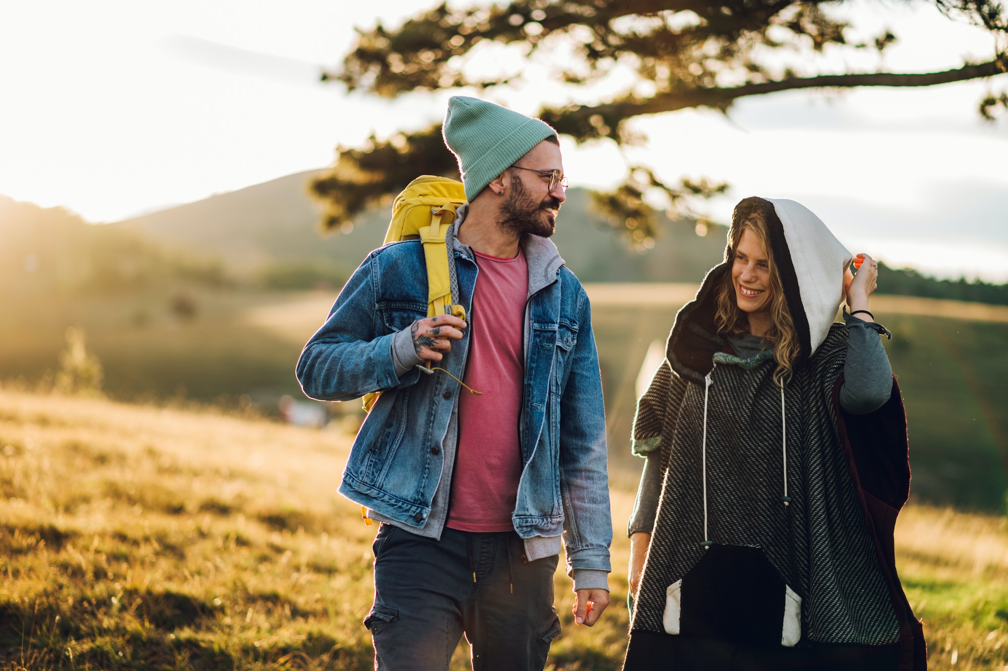 Couple of hikers walking on a mountain trail during a vacation